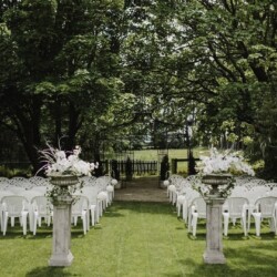 Rows of neatly arranged white chairs sitting before the ceremony area